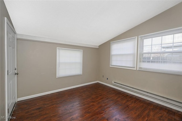 spare room with a baseboard radiator, lofted ceiling, baseboards, and wood finished floors