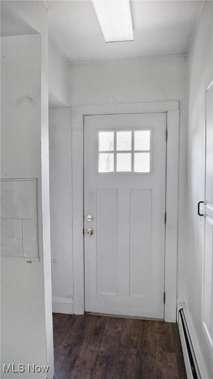 foyer featuring dark wood-style floors and a baseboard heating unit