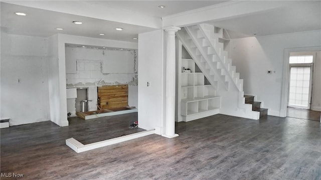 interior space with built in features, recessed lighting, stairway, wood finished floors, and ornate columns