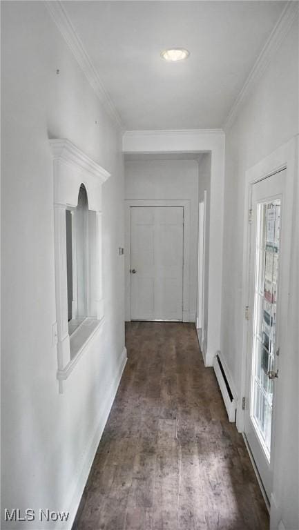 hall featuring a wealth of natural light, a baseboard heating unit, dark wood-type flooring, and ornamental molding