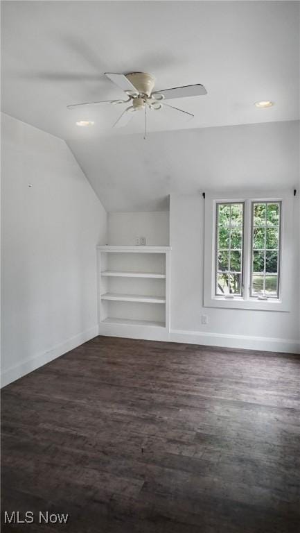 additional living space with ceiling fan, baseboards, vaulted ceiling, and wood finished floors