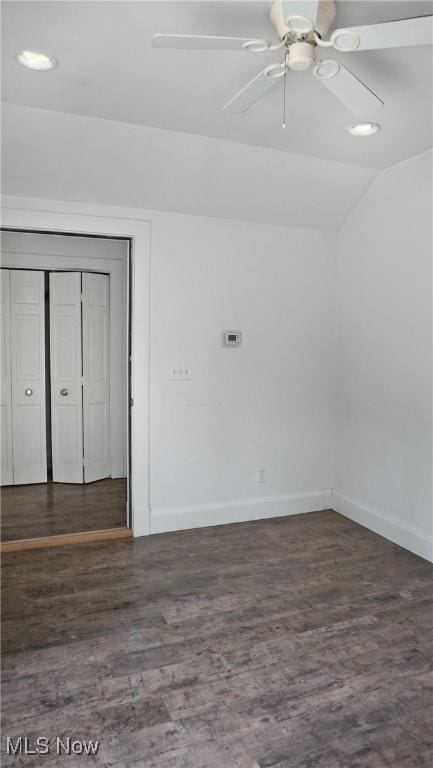 interior space with lofted ceiling, ceiling fan, baseboards, and wood finished floors