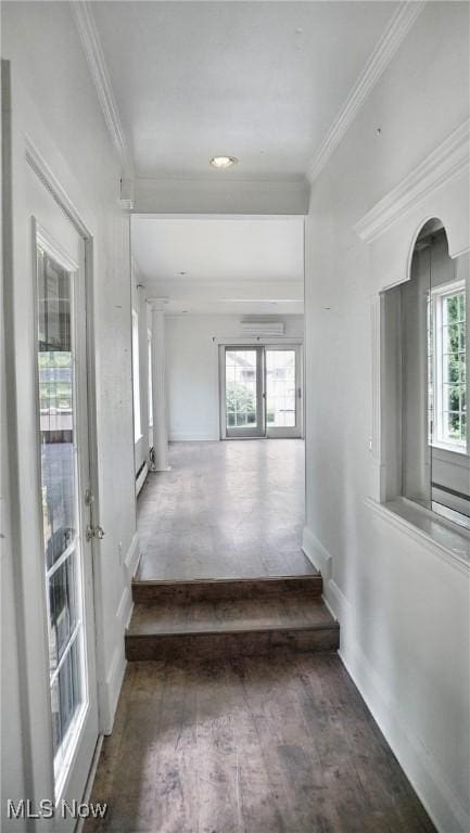 hallway with plenty of natural light, wood finished floors, and crown molding