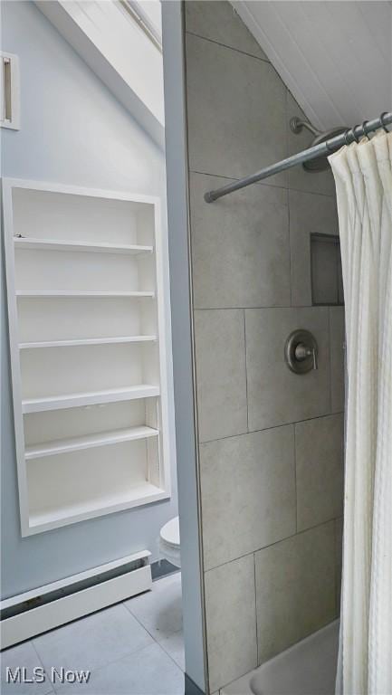 full bath featuring a stall shower, a baseboard radiator, and toilet