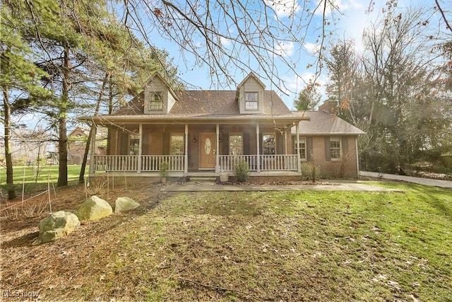 cape cod home featuring covered porch, brick siding, and a front lawn