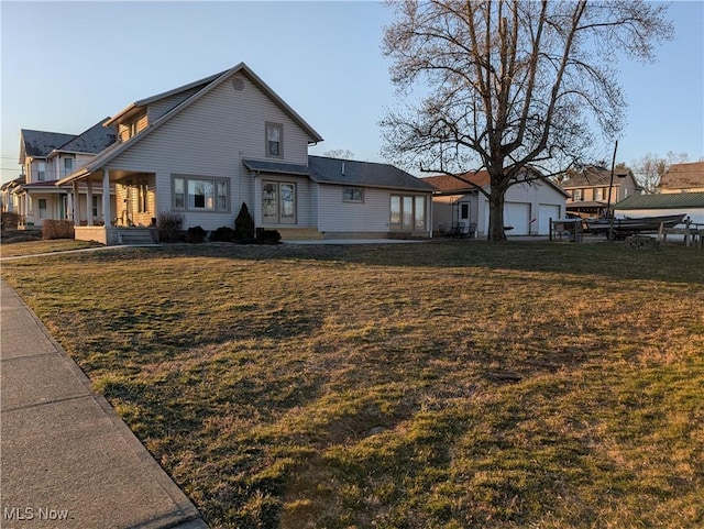 view of front of house featuring a front yard and an outdoor structure