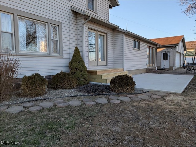 view of home's exterior with an outbuilding, crawl space, and entry steps