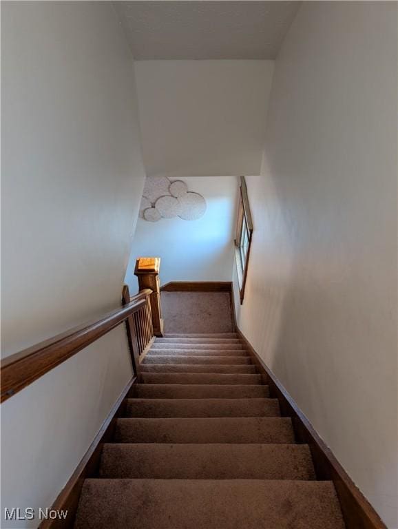 staircase featuring baseboards