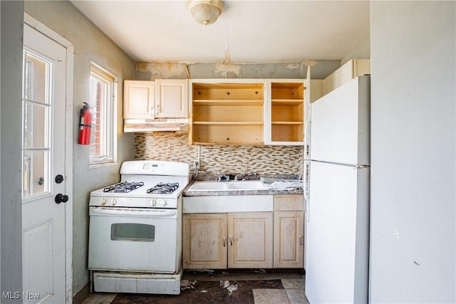 kitchen with white appliances, decorative backsplash, under cabinet range hood, open shelves, and a sink