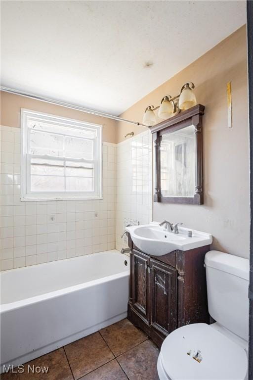 bathroom with toilet, shower / bath combination, tile patterned flooring, and vanity