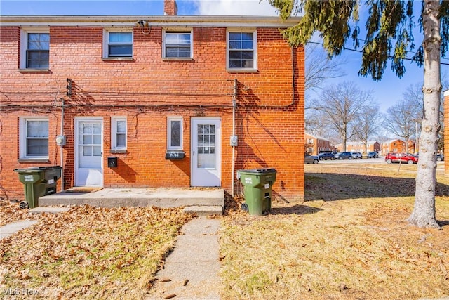 rear view of property featuring brick siding