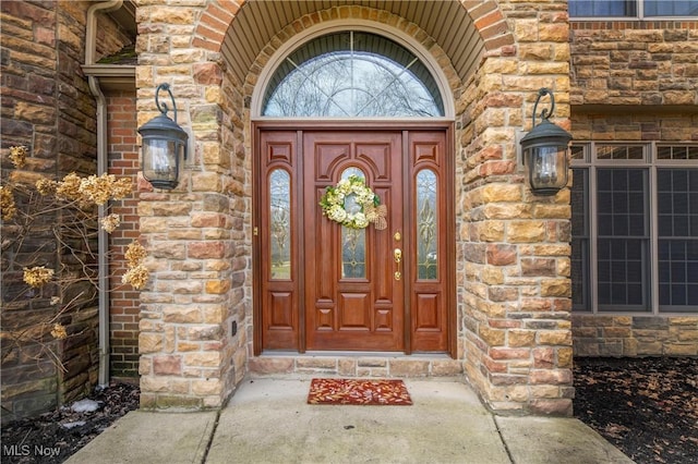 view of exterior entry featuring stone siding