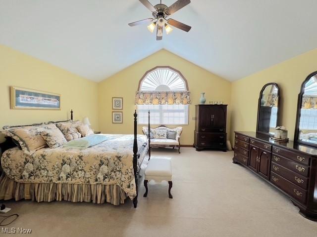 bedroom featuring lofted ceiling, light carpet, and ceiling fan