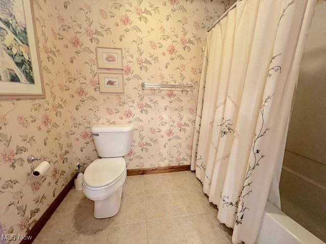 bathroom featuring toilet, wallpapered walls, baseboards, and tile patterned floors