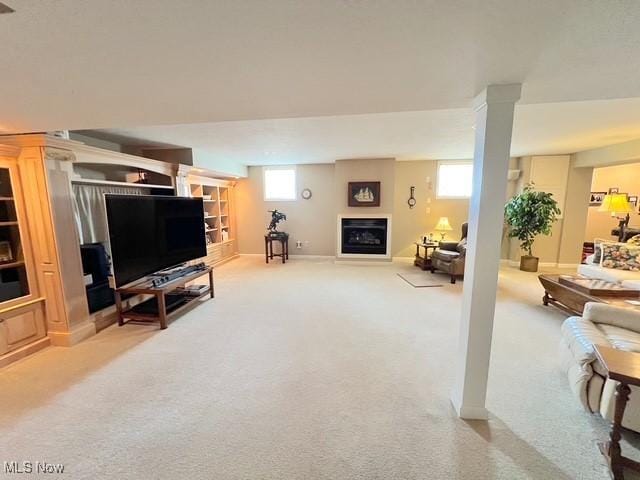 carpeted living area featuring a fireplace