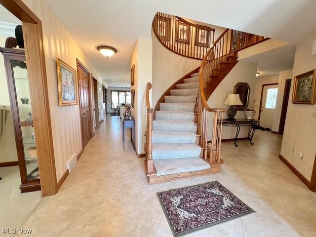 stairs with tile patterned flooring and baseboards