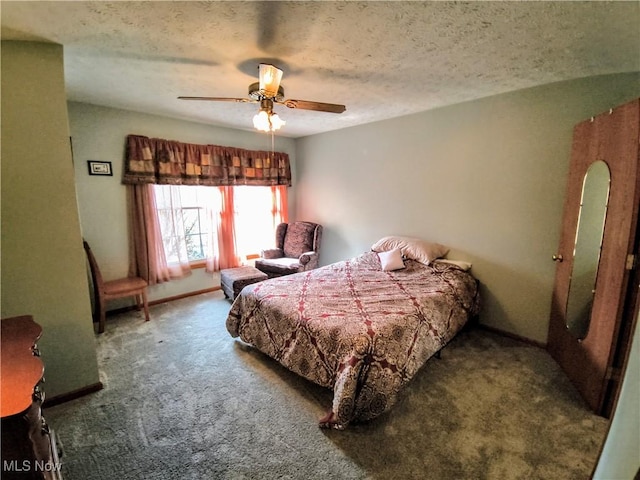 carpeted bedroom featuring a ceiling fan and a textured ceiling