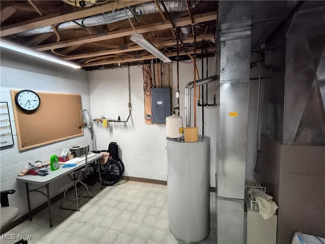 unfinished basement with concrete block wall, electric panel, and tile patterned floors