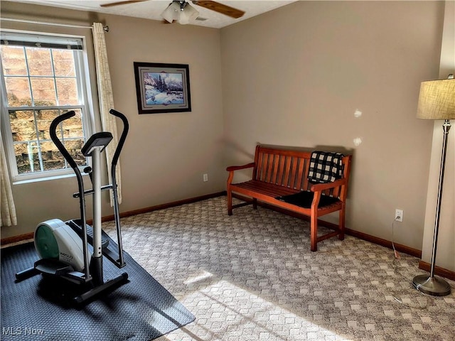 exercise room featuring a ceiling fan, carpet flooring, and baseboards