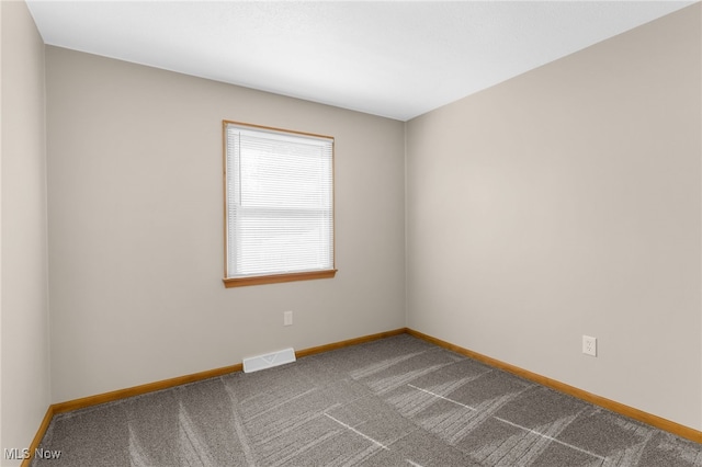 14045 Mahoning Ave, Lake Milton, OH 44451 - spare room with dark carpet, visible vents, and baseboards