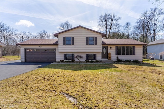 14045 Mahoning Ave, Lake Milton, OH 44451 - tri-level home featuring aphalt driveway, an attached garage, and a front yard