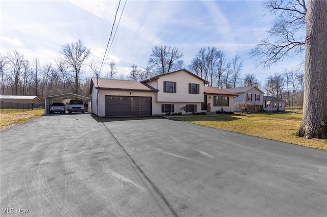 14045 Mahoning Ave, Lake Milton, OH 44451 - split level home with aphalt driveway, a carport, and a front yard