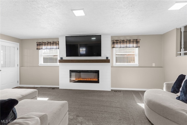 14045 Mahoning Ave, Lake Milton, OH 44451 - living room with a textured ceiling, a fireplace, baseboards, and carpet flooring