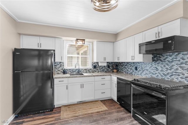 14045 Mahoning Ave, Lake Milton, OH 44451 - kitchen featuring dark wood finished floors, light countertops, white cabinetry, a sink, and black appliances