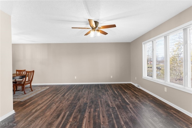 14045 Mahoning Ave, Lake Milton, OH 44451 - unfurnished room with ceiling fan, dark wood-type flooring, a textured ceiling, and baseboards