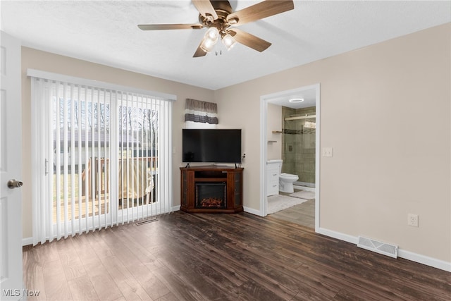 14045 Mahoning Ave, Lake Milton, OH 44451 - unfurnished living room featuring ceiling fan, dark wood-type flooring, visible vents, and baseboards
