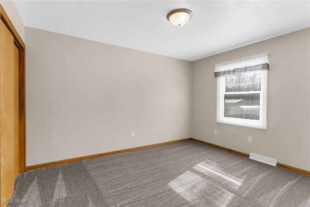 14045 Mahoning Ave, Lake Milton, OH 44451 - empty room featuring carpet floors, visible vents, and baseboards
