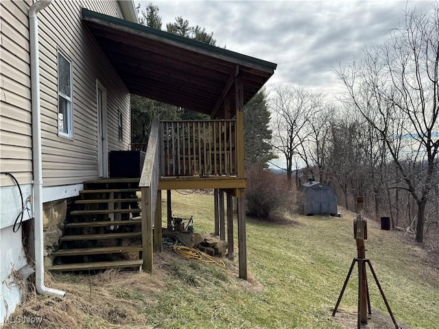 view of yard with an outbuilding, a wooden deck, and a shed