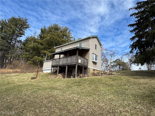 rear view of property with a deck and a lawn