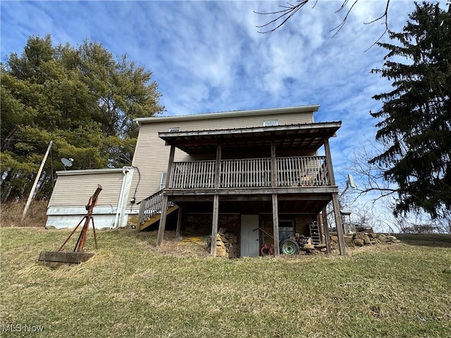 rear view of house with stairs, a yard, and a wooden deck