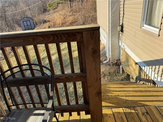 deck featuring a carport and an outdoor structure