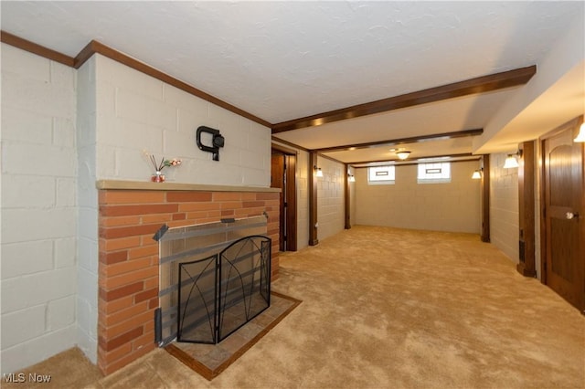 living room featuring concrete block wall, a brick fireplace, and carpet flooring