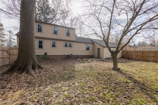 rear view of house with a fenced backyard