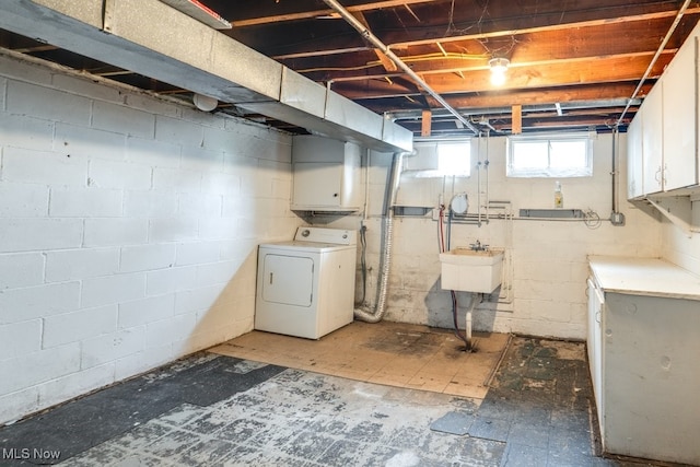 basement featuring washer / clothes dryer and a sink