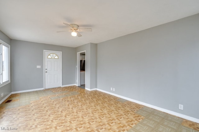 unfurnished room featuring ceiling fan, visible vents, and baseboards