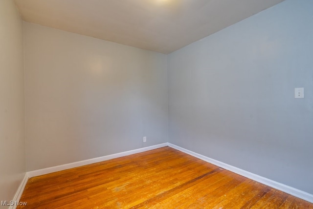 unfurnished room featuring wood finished floors and baseboards