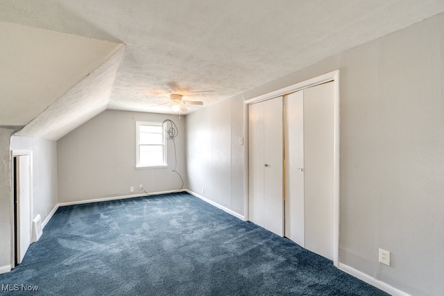 additional living space featuring a textured ceiling, ceiling fan, vaulted ceiling, and carpet