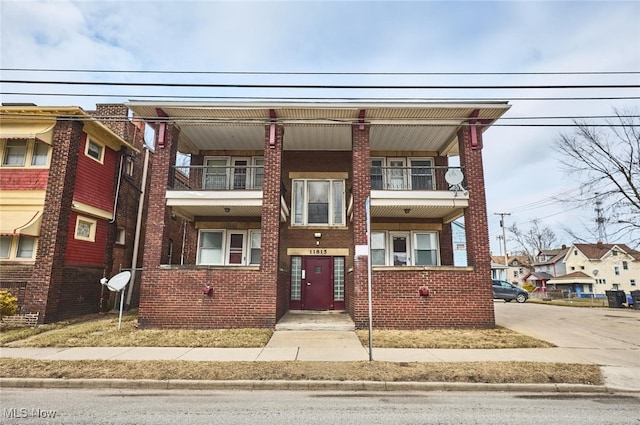 townhome / multi-family property featuring brick siding