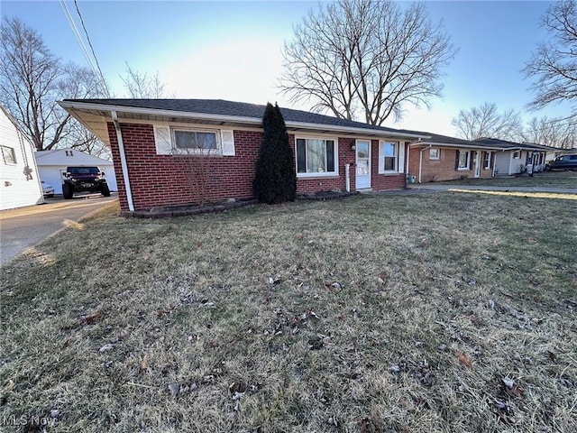 ranch-style house with brick siding and a front yard