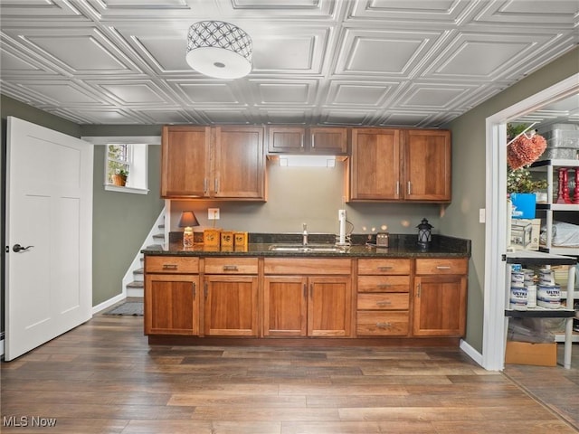 kitchen featuring a sink, an ornate ceiling, and brown cabinets