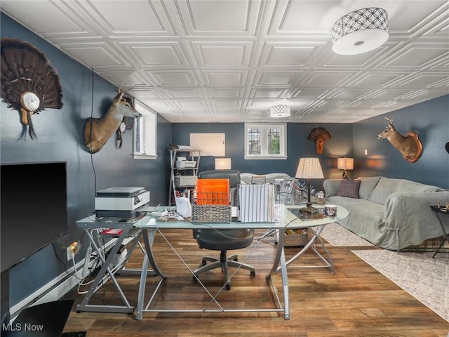 office area with an ornate ceiling and wood finished floors