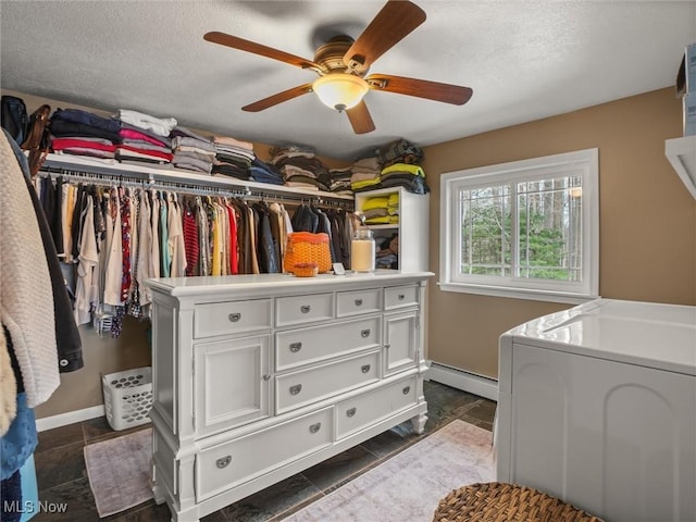 walk in closet featuring ceiling fan and a baseboard heating unit