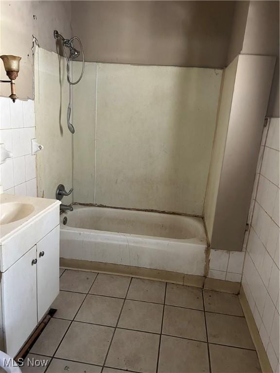 full bath featuring shower / bathtub combination, tile patterned flooring, tile walls, and vanity