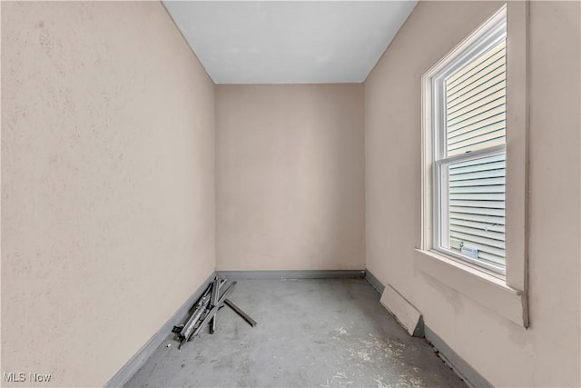 unfurnished room with concrete flooring, baseboards, and visible vents