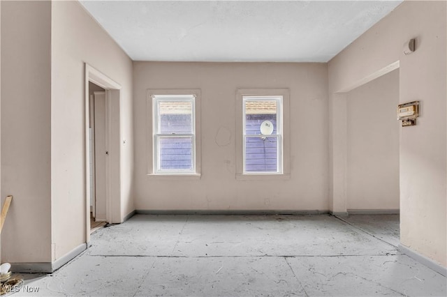 spare room featuring baseboards