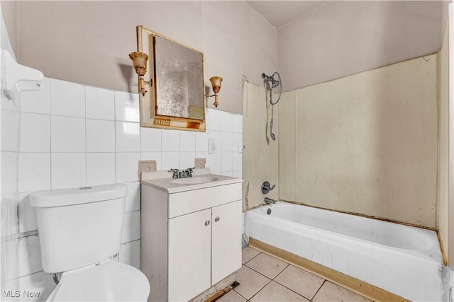 bathroom with bathtub / shower combination, toilet, vanity, tile patterned flooring, and tile walls